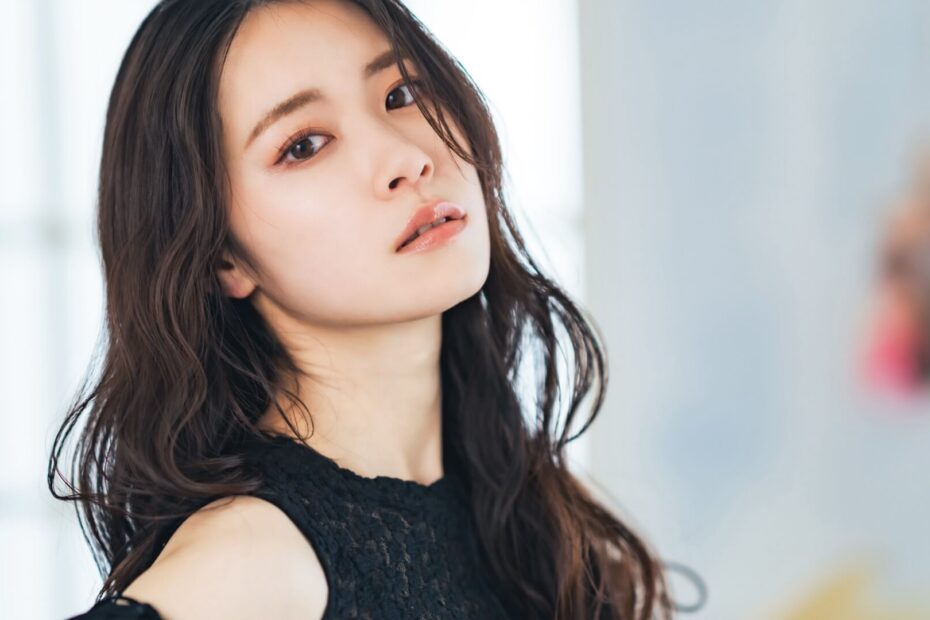 黒いレースのトップスを着て振り返る長い髪の女性
